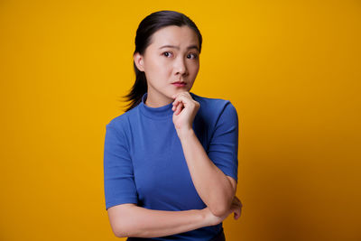 Portrait of boy against yellow background