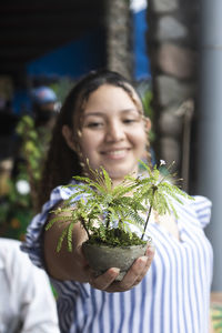 Latin woman with plant in hand