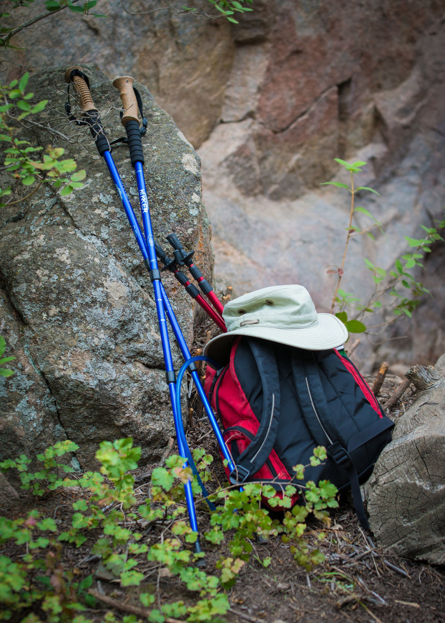 HIGH ANGLE VIEW OF UMBRELLAS ON ROCKS BY LAND