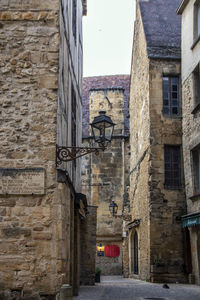 Narrow alley amidst buildings in city