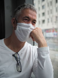 Portrait of man wearing mask in public transport