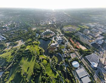 Flying around the munich olympia tower and the olympia stadium and also the bmw buildings