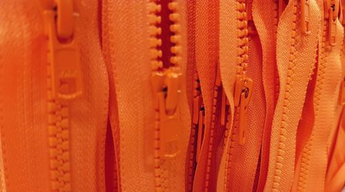 Full frame shot of orange zips