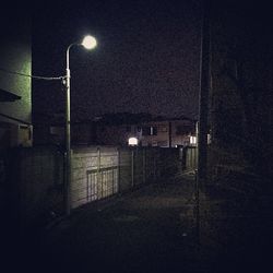 Empty illuminated street light at night