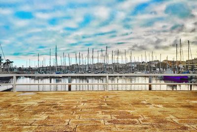 View of harbor against cloudy sky