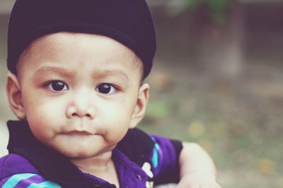 Close-up portrait of cute baby boy outdoors