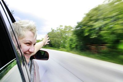 Portrait of man in car window