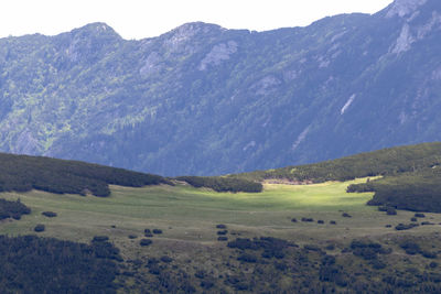 Scenic view of landscape and mountains against sky