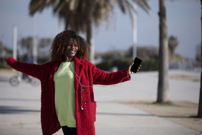 Rear view of woman standing on street