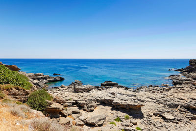 Scenic view of sea against clear blue sky