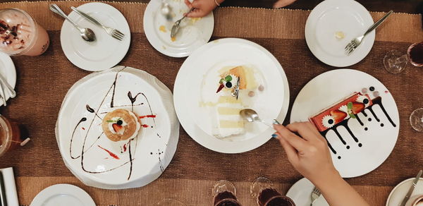 Directly above shot of woman holding food on table