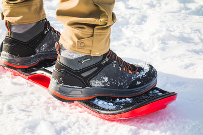 Low section of person on snowboard in snow