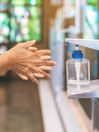 Close-up of hand holding glass bottle