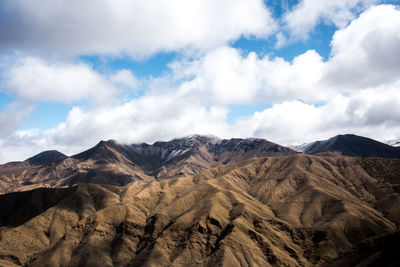 Scenic view of mountains against cloudy sky