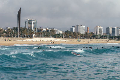 Panoramic view of sea and buildings against sky