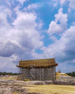 Low angle view of building on field against sky