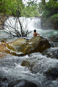 Boy standing on rock