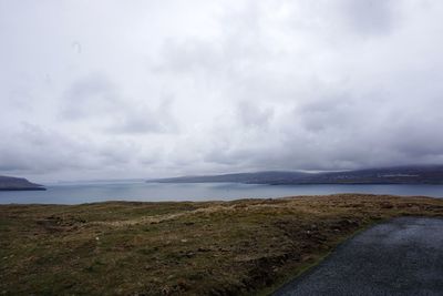 Scenic view of sea against cloudy sky