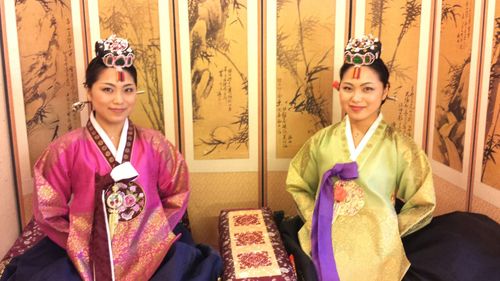 Portrait of smiling young brides wearing costumes