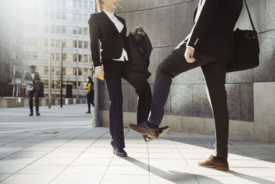 Business people using feet greeting during covid-19 pandemic