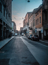 City street and buildings against sky