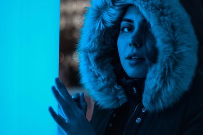 Close-up of woman with hand in snow