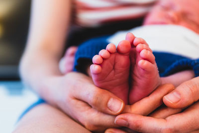 Midsection of mother holding baby