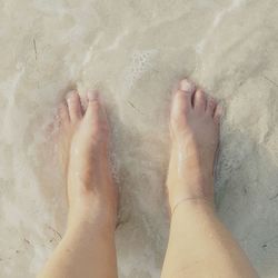 Low section of woman standing on tiled floor