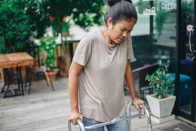 Woman looking at camera while standing on table