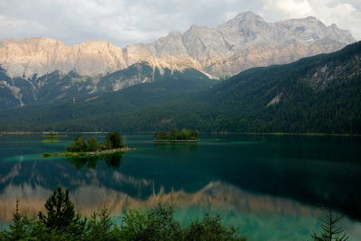 Scenic view of lake and mountains against sky