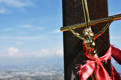 Low angle view of cross against sky