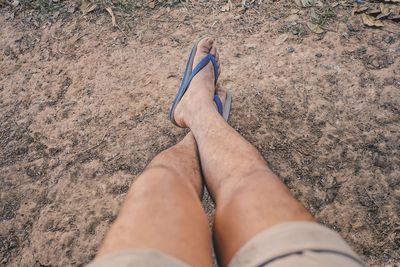 Low section of woman lying on land