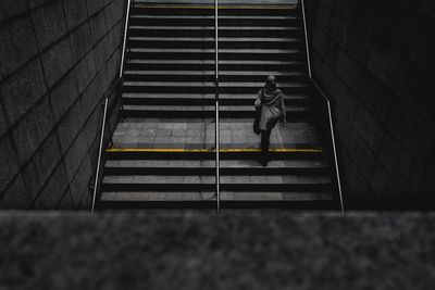 High angle view of man walking on staircase