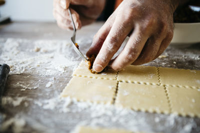 Cropped hands of male chef preparing food on table