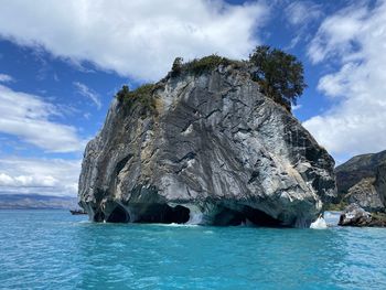 Scenic view of rock formation in sea against sky