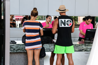 Rear view of two friends standing outdoors