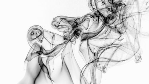 Close-up portrait of woman with reflection on water against white background