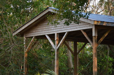 Low angle view of trees against built structure