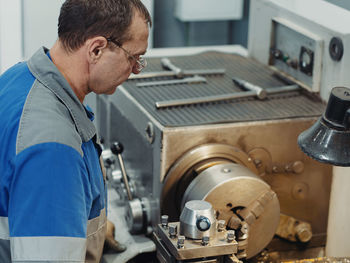 Side view of man working in workshop