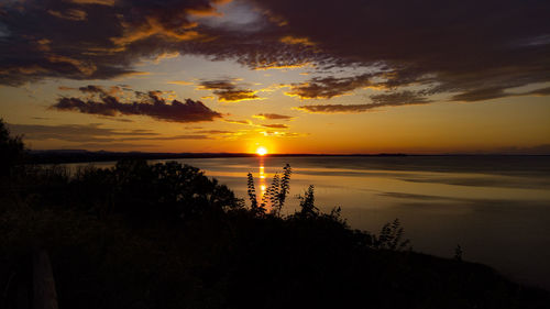 Scenic view of sea against romantic sky at sunset