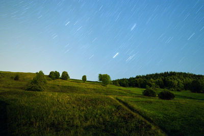 Scenic view of field against clear sky at night