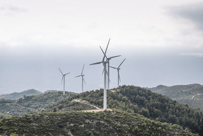 View of windmills against mountains
