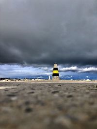Lifeguard hut on beach against sky