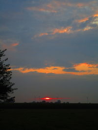 Scenic view of silhouette field against sky during sunset