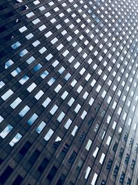 Low angle view of modern glass building in city