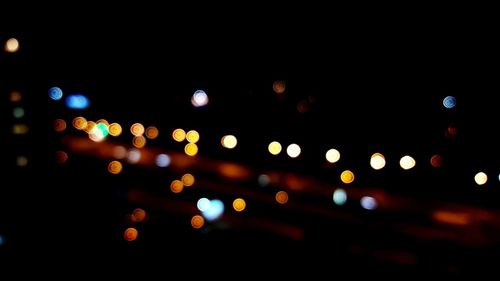 Low angle view of defocused lights at night