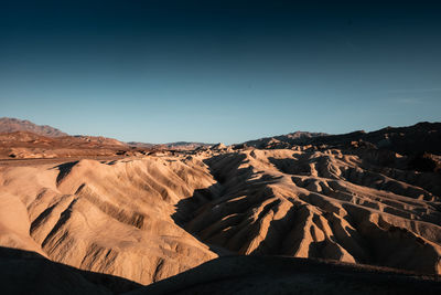 Scenic view of arid landscape against clear sky