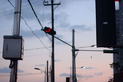 Close-up of road signal against sky