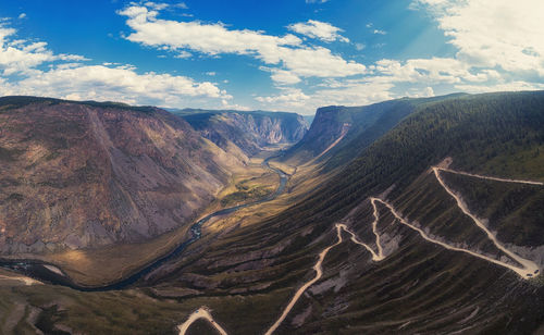 Aerial view of mountain range against cloudy sky