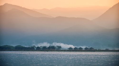 Scenic view of lake and mountains against sky